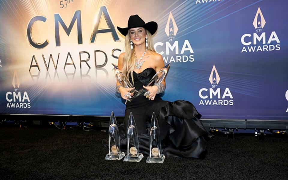 Lainey Wilson with her awards in November