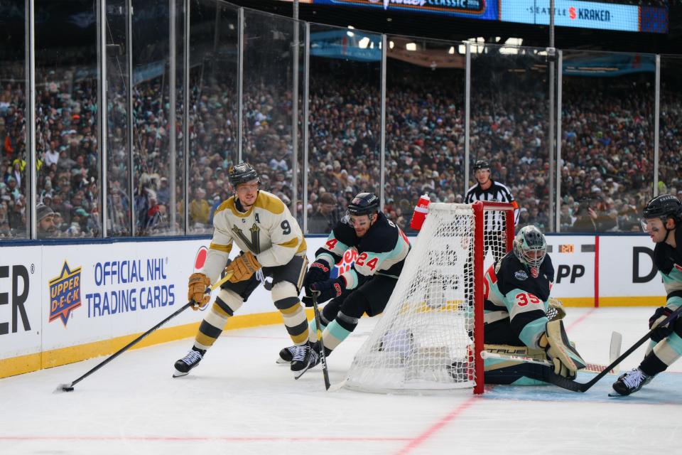Jan 1, 2024; Seattle, Washington, USA; Vegas Golden Knights center Jack Eichel (9) plays the puck behind the net while Seattle Kraken defenseman Jamie Oleksiak (24) defends during the first period in the 2024 Winter Classic ice hockey game at T-Mobile Park. Mandatory Credit: Steven Bisig-USA TODAY Sports