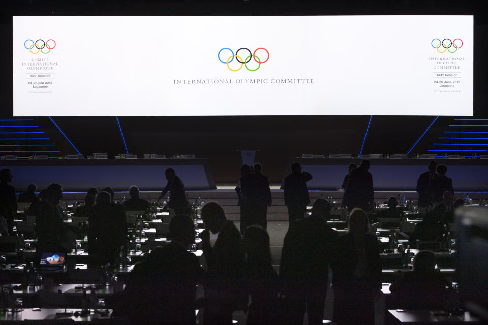 IOC members arrive for the first day of the 134th Session of the International Olympic Committee (IOC), at the SwissTech Convention Centre, in Lausanne, Switzerland, Monday, June 24, 2019. The host city of the 2026 Olympic Winter Games will be decided during the134th IOC Session. Stockholm-Are in Sweden and Milan-Cortina in Italy are the two candidate cities for the Olympic Winter Games 2026. (Laurent Gillieron/Keystone via AP)