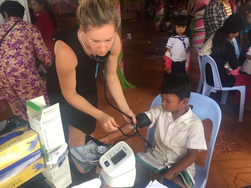 Jessica Manning uses a stethoscope on a healthy child in Chbar Mon, Kampong Speu Province