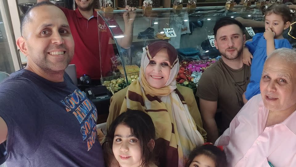 Happier times: writer Hani Almadhoun (left) buying Eid candy with his family in Gaza city during a visit home over the summer. - Hani Almadhoun