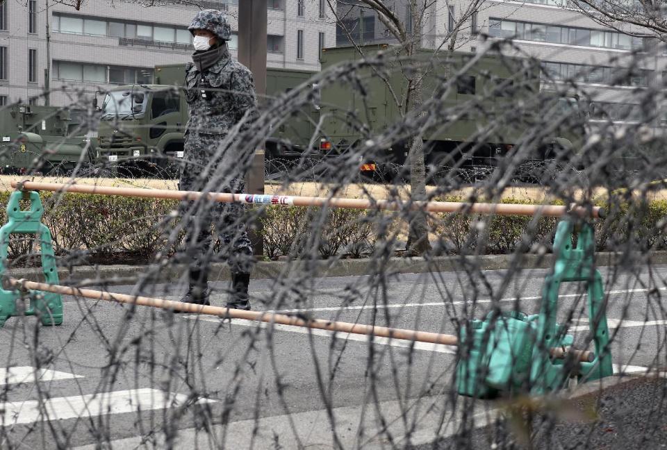 A member of Japan Self-Defense Force stands by a PAC-3 Patriot missile unit deployed against the North Korea's missile firing, at the Defense Ministry in Tokyo, Monday, March 6, 2017. North Korea on Monday fired four banned ballistic missiles that flew about 1,000 kilometers (620 miles), with three of them landing in Japan's exclusive economic zone, South Korean and Japanese officials said, in an apparent reaction to huge military drills by Washington and Seoul that Pyongyang insists are an invasion rehearsal. (AP Photo/Shizuo Kambayashi)