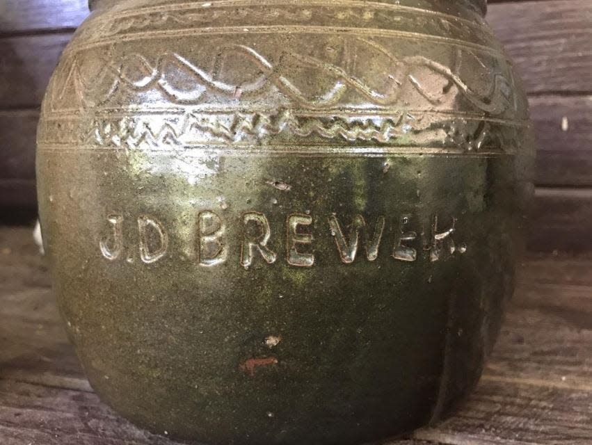 The jar is marked by the pottery J.D. Brewer.