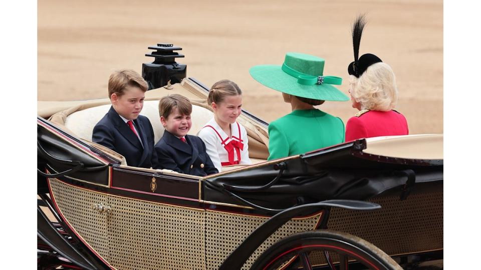 Prince George, Princess Charlotte and Prince Louis ride in a horse-drawn carriage with Princess Kate and Queen Camilla at Trooping the Colour