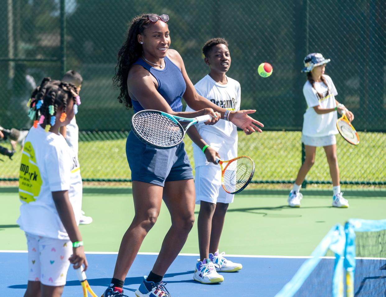 Coco Gauff gives a few lessons to kids after a ceremony celebrating the two refurbished public tennis courts at Pompey Park as part of USTA's US Open Legacy Initiative, which was created in celebration of Gauff's 2023 U.S. Open women's singles on March 19, 2024 in Delray Beach, Florida.