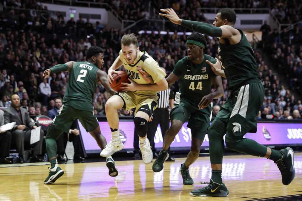 Purdue guard Sasha Stefanovic (55) hops between Michigan State guard Rocket Watts (2) and forward Gabe Brown (44) during the second half of an NCAA college basketball game in West Lafayette, Ind., Sunday, Jan. 12, 2020. (AP Photo/Michael Conroy)