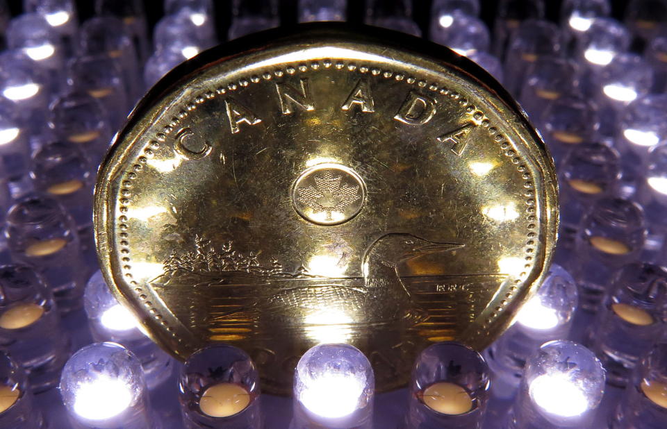 A loonie is pictured in Vancouver on April, 2014. Canada’s annual inflation rate accelerated to two per cent last month as higher costs for airfares and fresh vegetables offset cheaper prices at the pump. (THE CANADIAN PRESS/Jonathan Hayward)