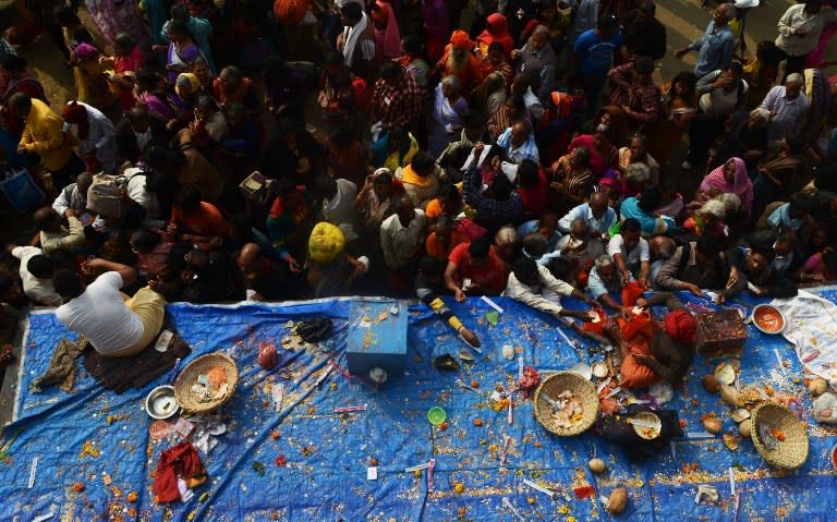 <p>Indian Hindu devotees offer prayers at a temple on Gangasagar Island around 150 km south of Kolkata on January 14, 2016. More than 500,000 Hindu pilgrims and sadhus – holy men – are expected to gather at the confluence of the River Ganges and the Bay of Bengal during the Gangasagar Mela to take a ‘holy dip’ in the ocean on the occasion of Makar Sankranti, a holy day of the Hindu calendar considered to be of great religious significance in Hindu mythology. </p>