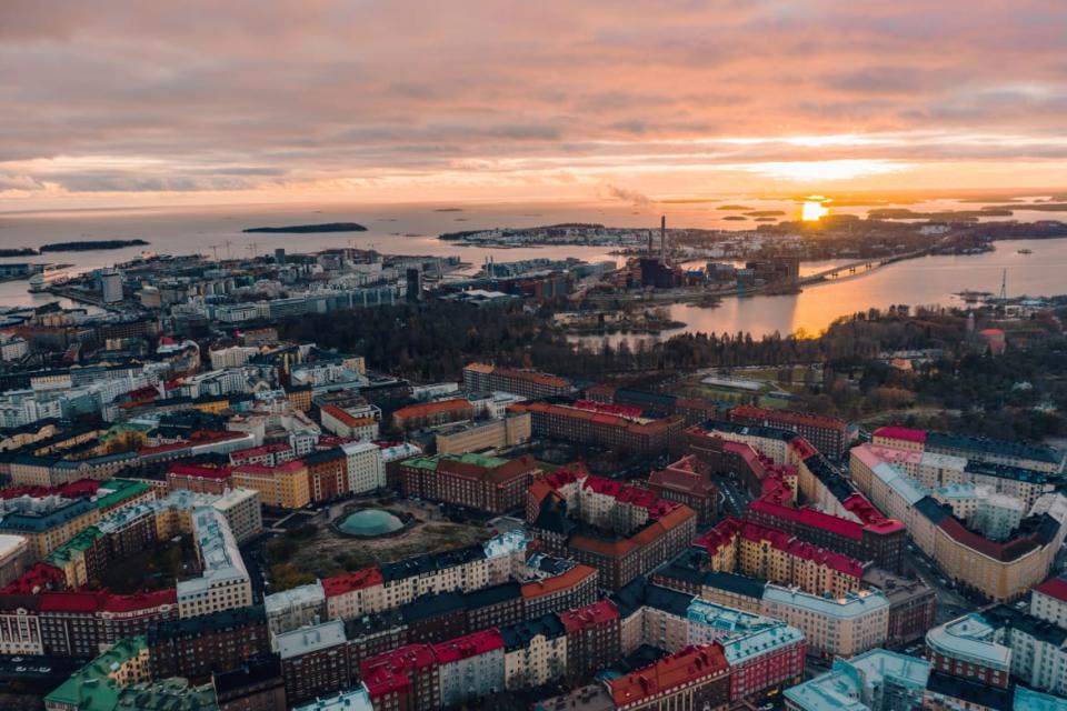 An aerial photograph of the exterior of Temppeliaukio Church in Helsinki, Finland.