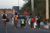 Venezuelan migrants walk on the Pan-American Highway, after crossing the border Peru - Ecuador after stricter entry requirements went into effect, in Tumbes, Peru, Saturday, June 15, 2019. With its relatively stable economy and flexible immigration laws, Peru has become a main destination for millions of Venezuelans escaping hyperinflation, medical shortages and political repression at home. (AP Photo/Martin Mejia)