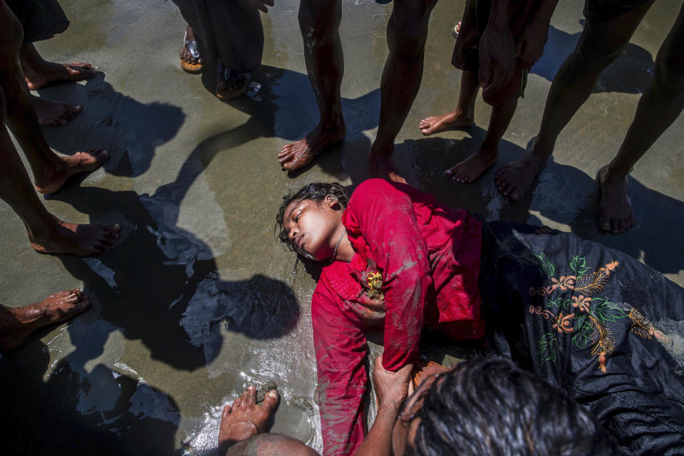 <p>A Rohingya Muslim woman, who crossed over from Myanmar into Bangladesh, lies unconscious on the shore of the Bay of Bangal after the boat she was traveling in capsized at Shah Porir Dwip, Bangladesh, Thursday, Sept. 14, 2017. (Photo: Dar Yasin/AP) </p>