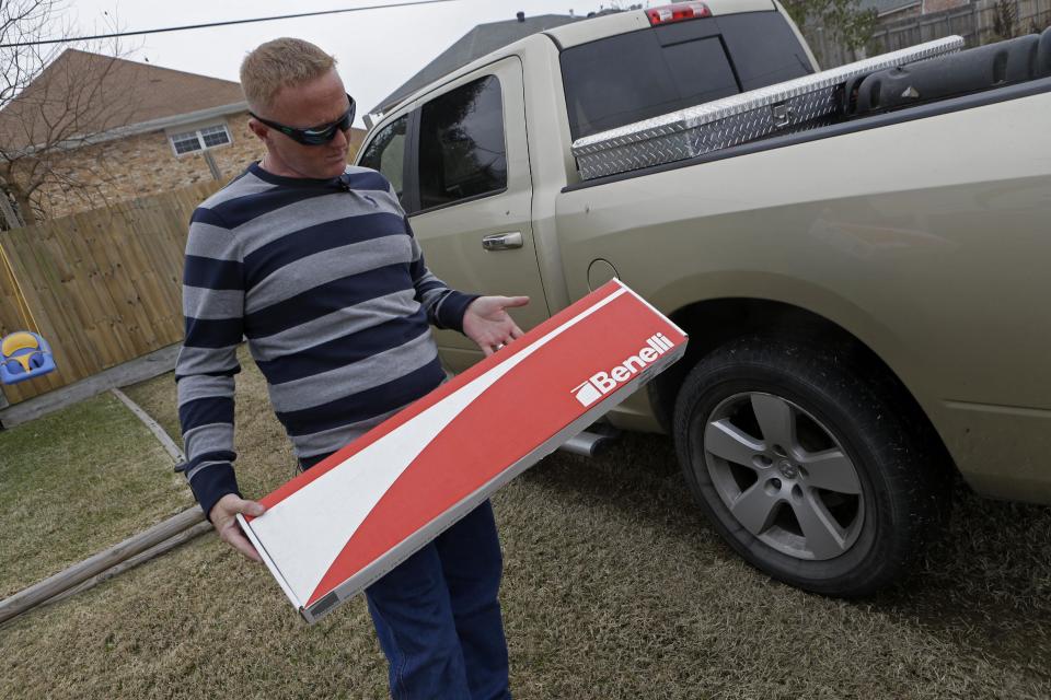 In this Friday, Jan. 10, 2014 photo, Kainan McAllister, brother of Denise Freeman, shows the box of the shotgun, purchased and owned by Denise's husband, Benjamin Freeman, in Chalmette, La. Benjamin killed Denise, then he used the gun to kill several other victims in a killing spree. The shootings stunned the bayou community 50 miles southwest of New Orleans. Investigators, victims and grieving family members don’t know exactly what set off Freeman’s rampage. But the shootings raised concerns about whether Louisiana law provides adequate safeguards to keep guns away from troubled people. (AP Photo/Gerald Herbert)