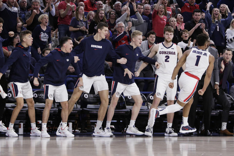 The Gonzaga bench reacts after guard Admon Gilder (1) dunked during the second half of the team's NCAA college basketball game against BYU in Spokane, Wash., Saturday, Jan. 18, 2020. Gonzaga won 92-69. (AP Photo/Young Kwak)