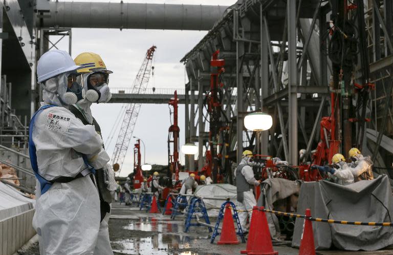 Workers construct an ice wall at the tsunami-crippled Fukushima nuclear plant in Okuma, Fukushima Prefecture, northeast of Tokyo on July 9, 2014