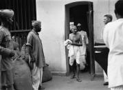 Mahatma Gandhi leaves a jail in Calcutta after visiting political prisoners as part of negotiations to secure their release. (Photo by © Hulton-Deutsch Collection/CORBIS/Corbis via Getty Images)