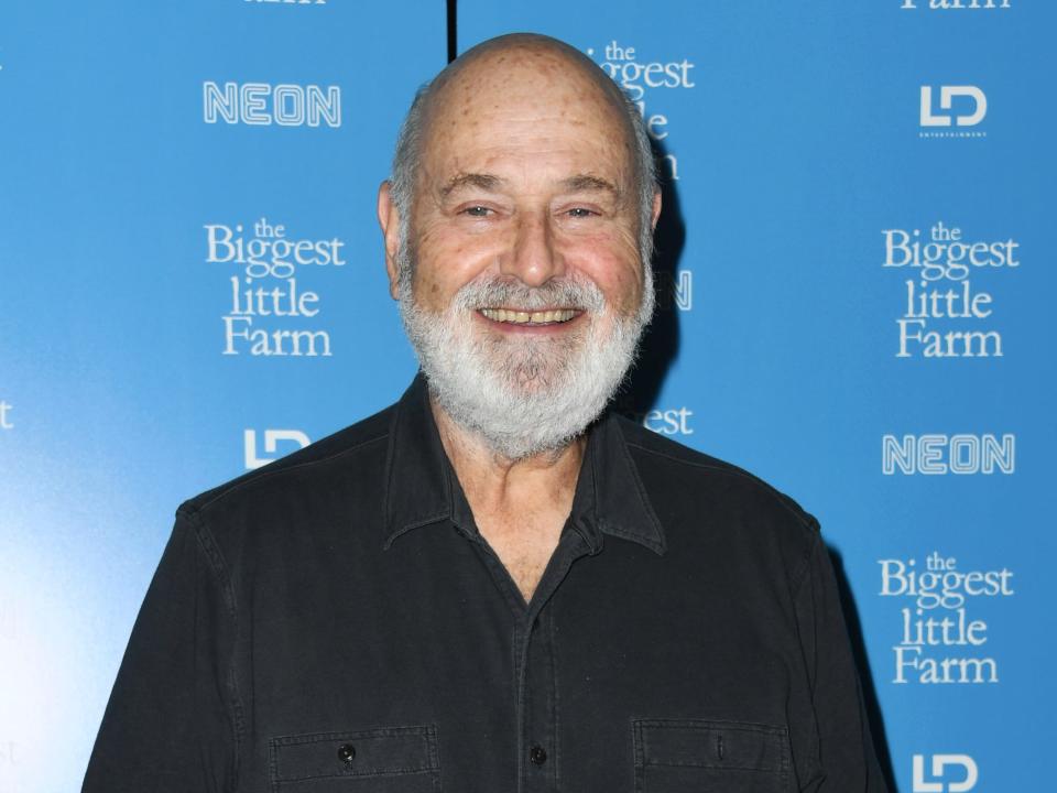 Rob Reiner in black shirt and blue background