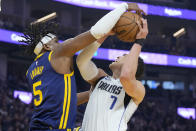 Dallas Mavericks center Dwight Powell (7) is fouled by Golden State Warriors forward Kevon Looney (5) during the first half of an NBA basketball game in San Francisco, Saturday, Feb. 4, 2023. (AP Photo/Jeff Chiu)