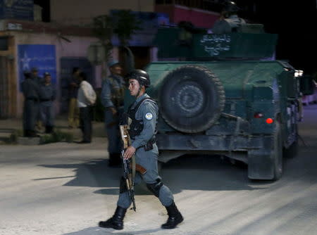 An Afghan policeman keeps watch at the site of an attack in Kabul May 13, 2015. REUTERS/Omar Sobhani