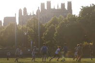 FILE - In this May 6, 2021, file photo, University of Chicago men's rugby team players practice on the Midway Plaisance near the campus in Chicago. Even as restrictions relax across much of the United States, colleges and universities have taken new steps to police campus life as the virus spreads through students who are among the last adults to get access to vaccines. (AP Photo/Shafkat Anowar, File)