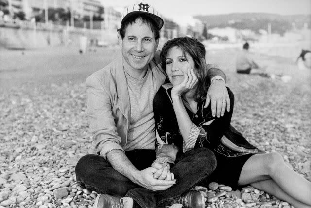 <p>Jean-Jacques LAPEYRONNIE/Gamma-Rapho via Getty</p> Paul Simon and Carrie Fisher in 1983.