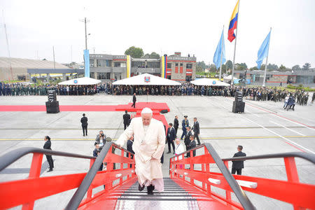 Pope Francis steps aboard a plane at the airport of Bogota on his way to Villavicencio, Colombia September 8, 2017. Osservatore Romano/Handout via REUTERS