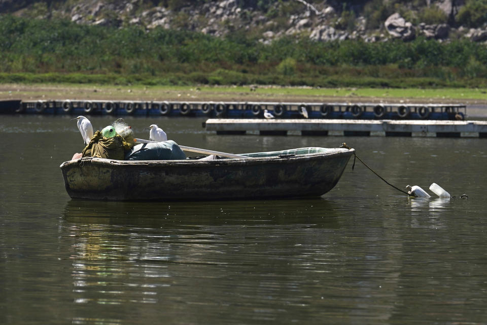 Birds perch on a moored boat on the Miguel Aleman dam in Valle de Bravo, Mexico, Thursday, March 14, 2024. According to Mexico’s National Water Commission, Valle de Bravo’s reservoir has fallen to 29% of its capacity – a historical low -- compared to one year ago when it was at 52%, while the country endures a drought and has imposed restrictions on water taken from the system. (AP Photo/Marco Ugarte)