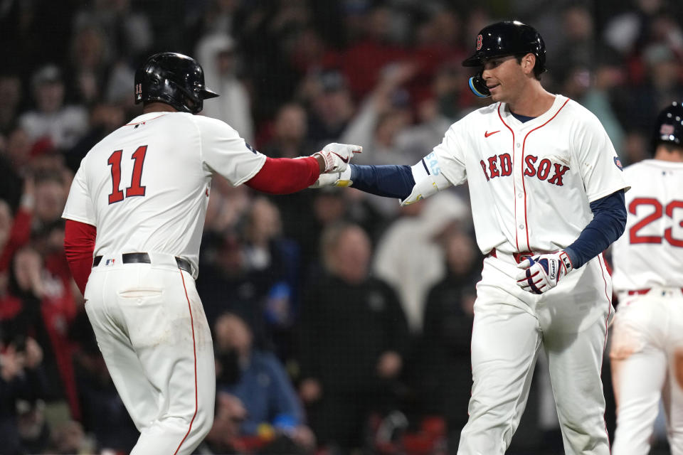 Boston Red Sox's Triston Casas, right, is congratulated by Rafael Devers (11) after his two-run home run during the fifth inning of a baseball game against the Baltimore Orioles, Wednesday, April 10, 2024, in Boston. (AP Photo/Charles Krupa)