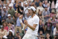 Italy's Jannik Sinner celebrates defeating Spain's Carlos Alcaraz during a men's fourth round singles match on day seven of the Wimbledon tennis championships in London, Sunday, July 3, 2022.(AP Photo/Kirsty Wigglesworth)