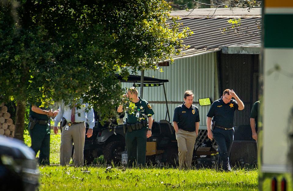 Polk County Sheriff Grady Judd and State Attorney Brian Haas walk through the crime scene at 4345 Foxtown South in Polk City, Deputy Blane Lane, 21, was killed early Tuesday morning while serving a warrant.