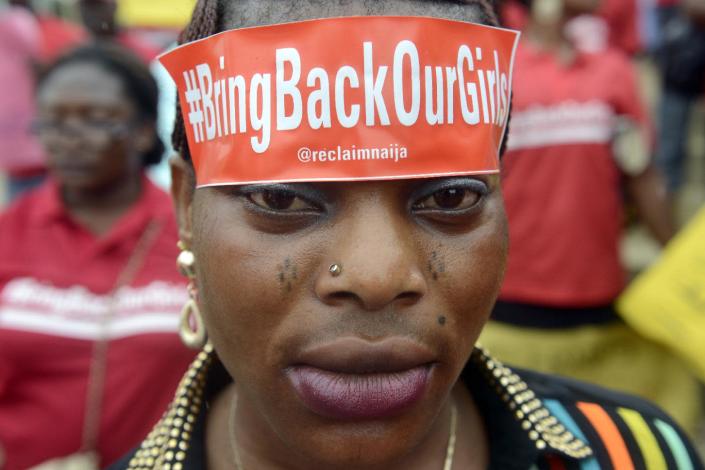 A woman with a sticker on her head bearing the slogan "Bring back our girls" marches for the release of the abducted Chibok school girls in Lagos on May 29, 2014 (AFP Photo/Pius Utomi Ekpei)