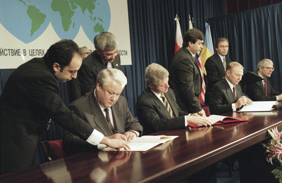 FILE - Russian President Boris Yeltsin, left, U.S. President Bill Clinton, Ukrainian President Leonid Kuchma, and British Prime Minister John Major, far right, sign the Nuclear Non-Proliferation Treaty during the Commission on Security and Cooperation in Europe (CSCE) summit in Budapest, Hungary, Monday, Dec. 5, 1994. A major United Nations meeting on the landmark nuclear Non-Proliferation Treaty is starting Monday, Aug. 1, 2022, after a long delay due to the COVID-19 pandemic, as Russia’s war in Ukraine has reanimated fears of nuclear confrontation and cranked up the urgency of trying reinforce the 50-year-old treaty. (AP Photo/Marcy Nighswander, File)