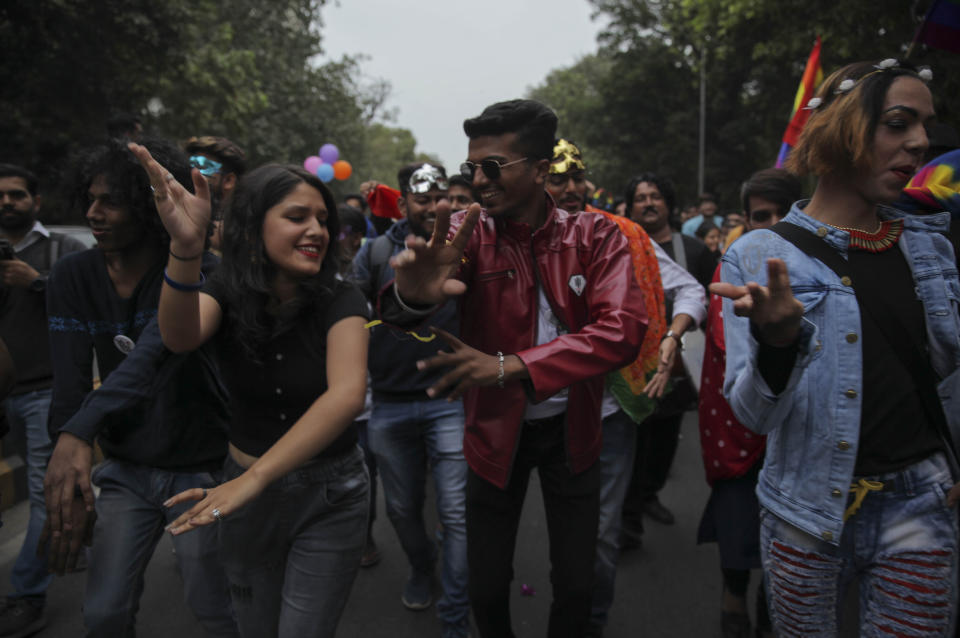 Members of the LGBTQ community and their supporters dance during the annual Delhi Queer Pride parade in New Delhi, India, Sunday, Nov.24, 2019. More than 1,000 members of the LGBTQ community and their supporters marched through New Delhi to celebrate India’s sexual diversity, which they say is progressing but still has a long way to go to become a more accepting place for them. (AP Photo/ Rishabh R. Jain)