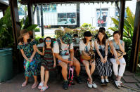<p>Tourists pose as they take a rest at a shed in Tumon tourist district on the island of Guam, a U.S. Pacific Territory, August 10, 2017. (Erik De Castro/Reuters) </p>