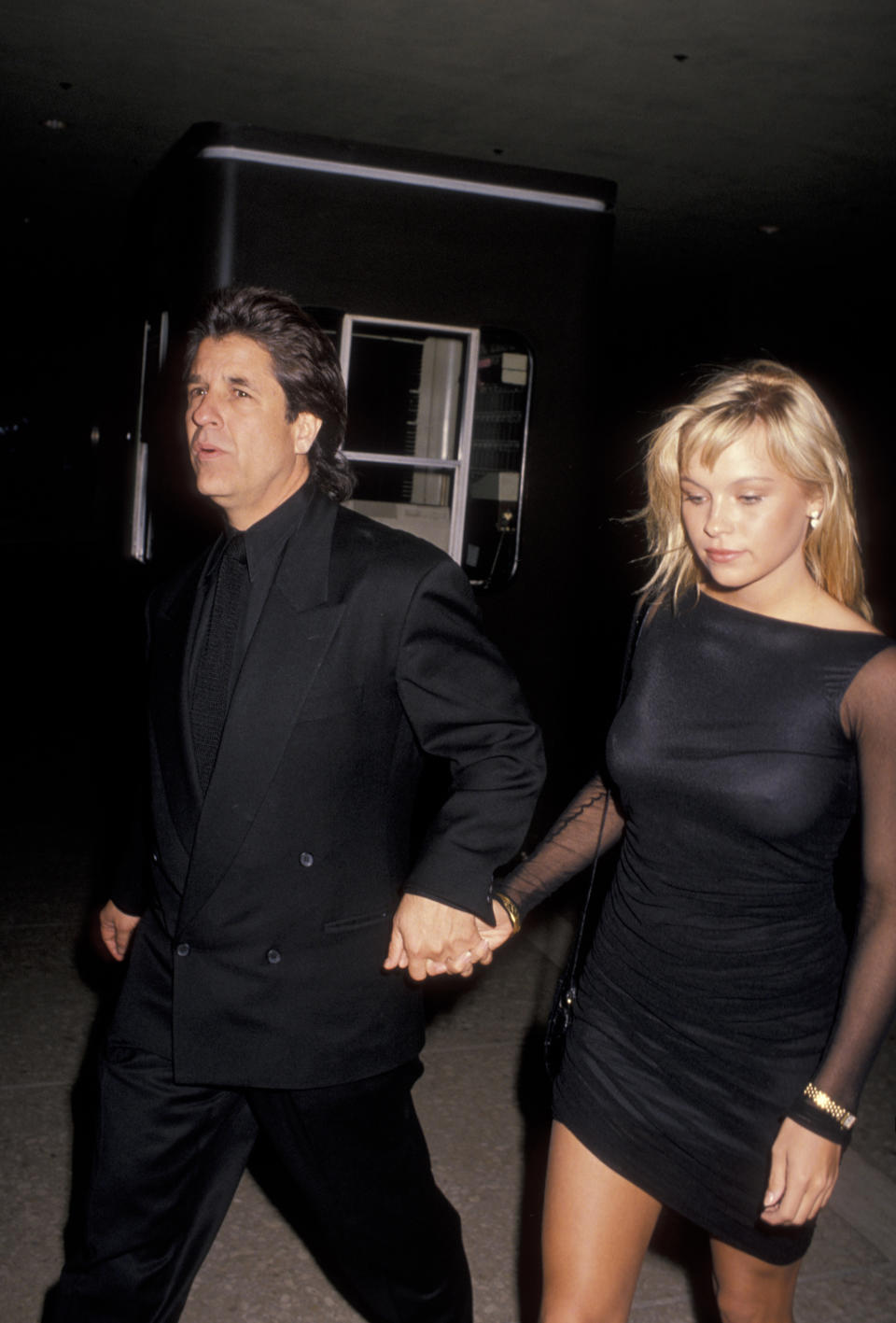 Producer Jon Peters and model Pamela Anderson attend the premiere of 'Glory' on December 11, 1989 at the Cineplex Odeon Cinema in Century City, California. (Photo by Ron Galella, Ltd./Ron Galella Collection via Getty Images)