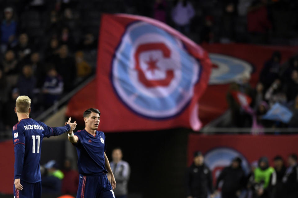 Chicago Fire's George Koutsias (19) celebrates with teammate Kacper Przybylko (11) after defeating the Minnesota United 2-1 in an MLS soccer game Saturday, April 8, 2023 in Chicago. This was Koutsias' first MLS game after being called up from Greece. (AP Photo/Paul Beaty)