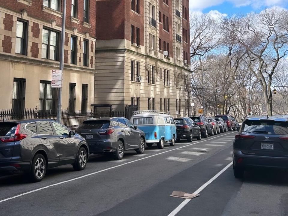 a blue van parked in NYC