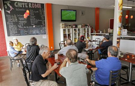 Customers at the Caffe Roma restaurant watch a live soccer telecast of Italian teams on a Sunday morning in Pompano Beach, Florida November 10, 2013. REUTERS/Joe Skipper