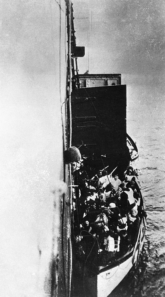 A small lifeboat on the side of a huge ship