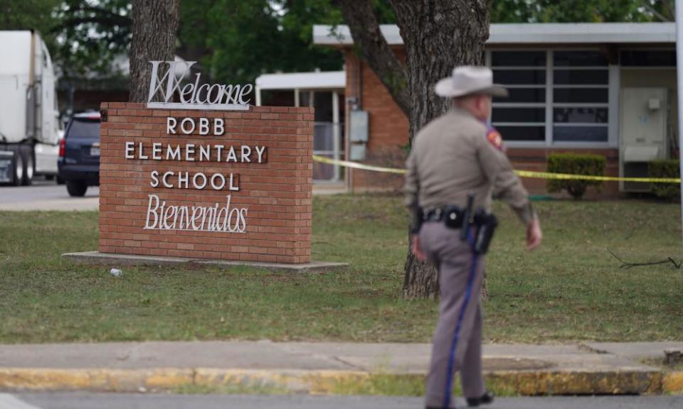 An officer walks outside Robb elementary in Uvalde, Texas.