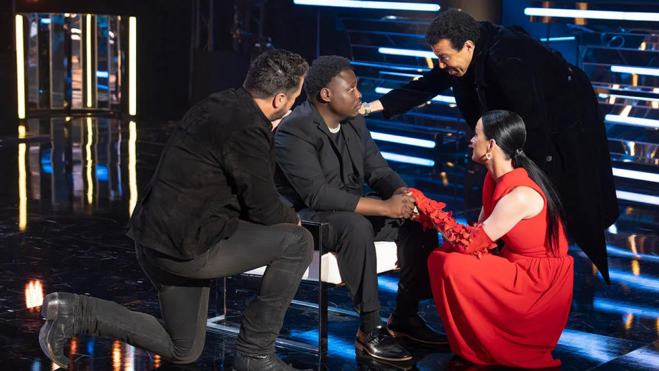 Luke Bryan, Lionel Richie, and Katy Perry comforting an American Idol contestant