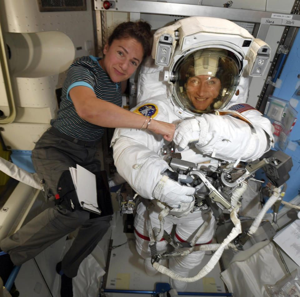 In this image released Friday, Oct. 4, 2019, by NASA, astronauts Christina Koch, right, and, Jessica Meir pose on the International Space Station. The first all-female spacewalk is back on, six months after a flap over spacesuits led to an embarrassing cancellation. NASA announced Friday that the two U.S. astronauts aboard the International Space Station will pair up for a spacewalk later this month. (NASA via AP)