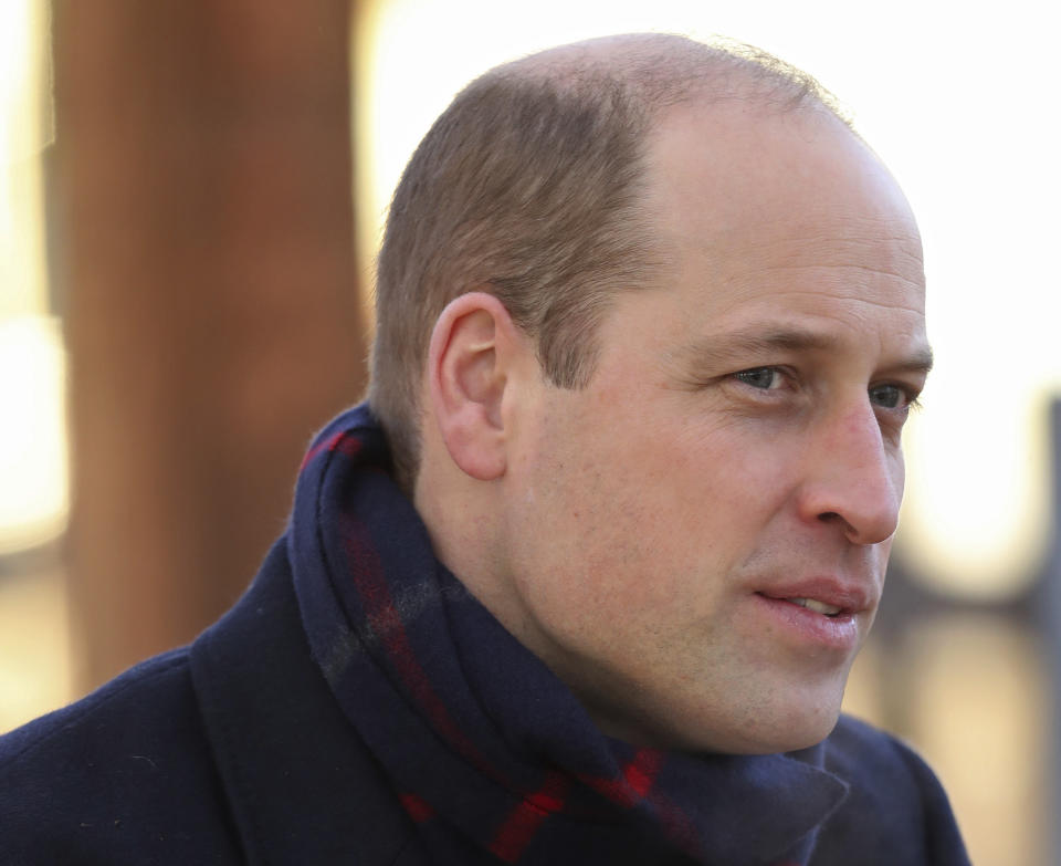 Britain's Prince William talks to members of the public at Cardiff Castle on Tuesday Dec. 8, 2020, in Cardiff, Wales. Prince William and Kate Duchess of Cambridge are undertaking a short tour of the UK by train ahead of the Christmas holidays to pay tribute to the inspiring work in local communities. (Chris Jackson/Pool via AP)