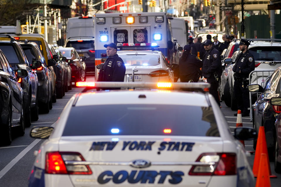 Security forces gather outside Manhattan Criminal Court, Monday, April 3, 2023, in New York. Former President Donald Trump is expected to travel to New York to face charges related to hush money payments. Trump is facing multiple charges of falsifying business records, including at least one felony offense, in the indictment handed up by a Manhattan grand jury. (AP Photo/John Minchillo)