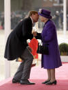 Netherlands' King Willem-Alexander bends down to kiss Britain's Queen Elizabeth II as she greets him upon his arrival to inspect an honour guard during a Ceremonial Welcome on Horse Guards Parade in London, Tuesday, Oct. 23, 2018. Dutch King Willem-Alexander and Queen Maxima are on a State Visit to Britain. (AP Photo/Matt Dunham, Pool)