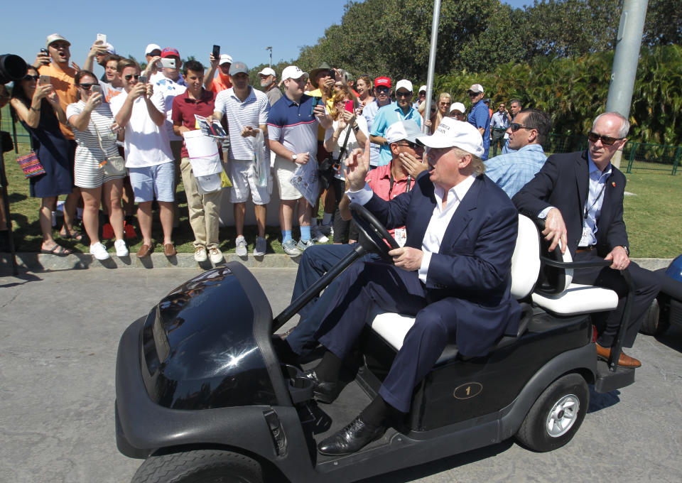 Then-presidential candidate Donald Trump drives himself around the golf course to watch the final round of the Cadillac Championship golf tournament on March 6, 2016, in Doral, Florida. (Photo: AP Photo/Luis Alvarez)