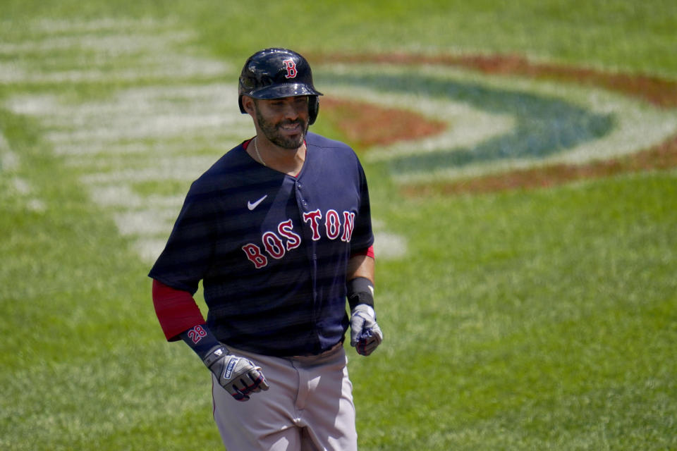 Boston Red Sox's J.D. Martinez trots to the dugout after hitting a solo home run off Baltimore Orioles starting pitcher Jorge Lopez during the third inning of a baseball game, Sunday, April 11, 2021, in Baltimore. (AP Photo/Julio Cortez)