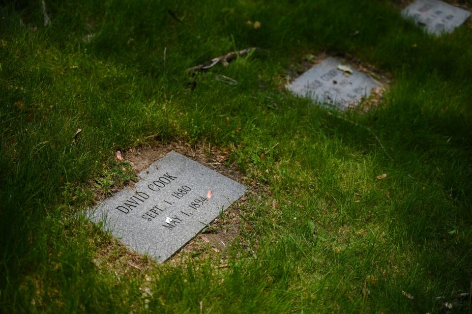 Grave markers at the burial site of those who died at the former Boys Training School on Tuesday, May 23, 2023, at Mt. Hope Cemetery in Lansing.