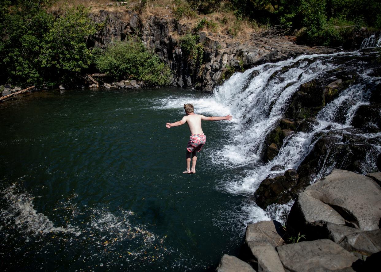 Jacob Speidel of Sandy jumps off a ledge into Scotts Mills Falls on July 23 in Scotts Mills.