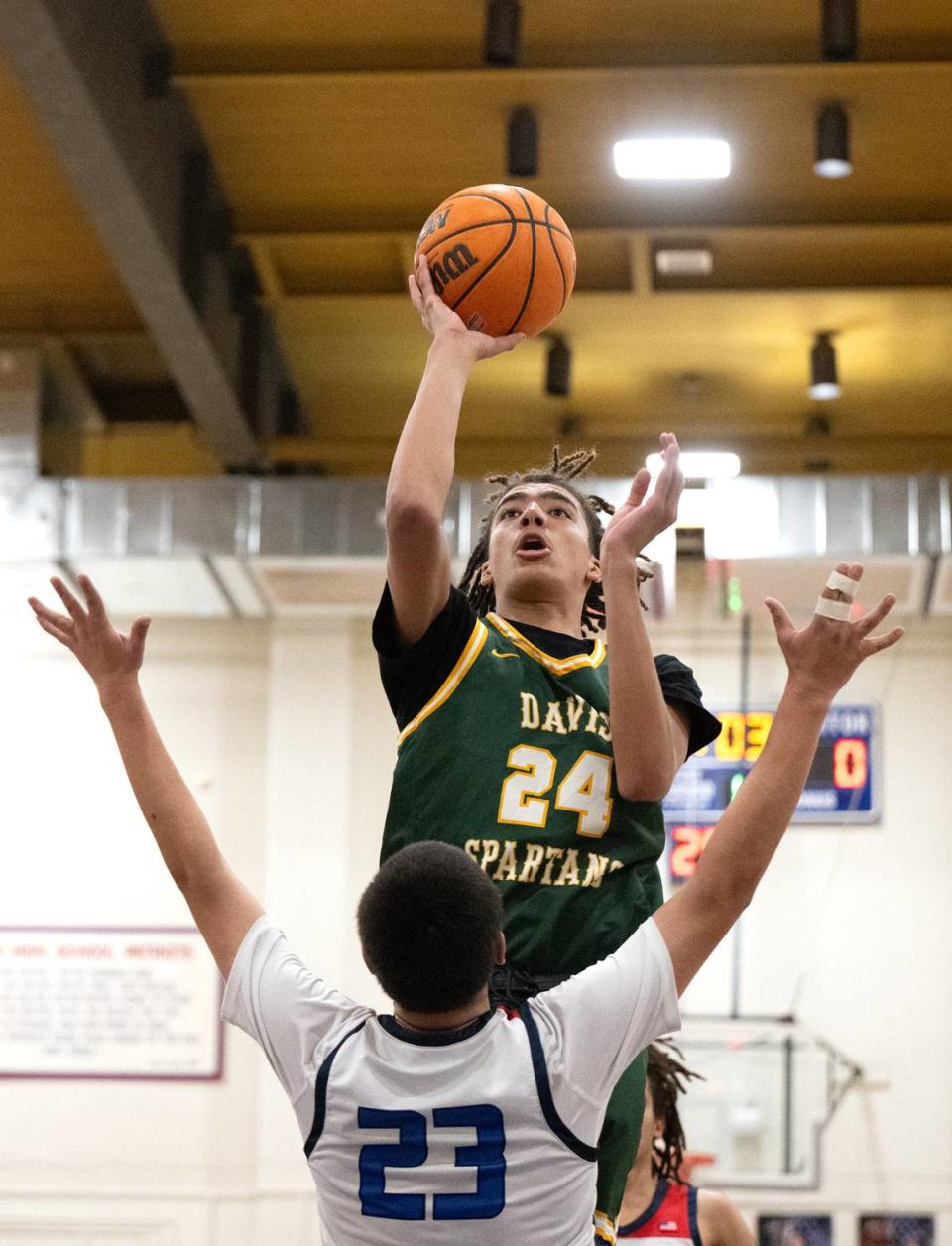 Davis’ Caynan Gardner scores over Beyer’s Nicholas Ruiz during the Western Athletic Conference game at Beyer High School in Modesto, Calif., Friday, Feb. 2, 2024.