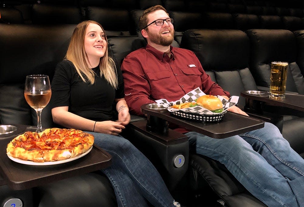 A couple enjoys a meal with a movie at Schulman's Movie Bowl and Grill in Sherman.